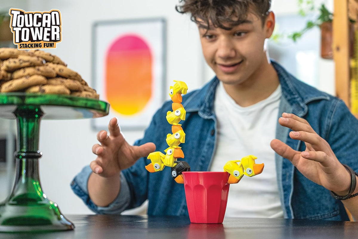 Toucan Tower yellow figures stacked in a balancing challenge