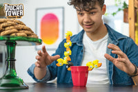Toucan Tower yellow figures stacked in a balancing challenge