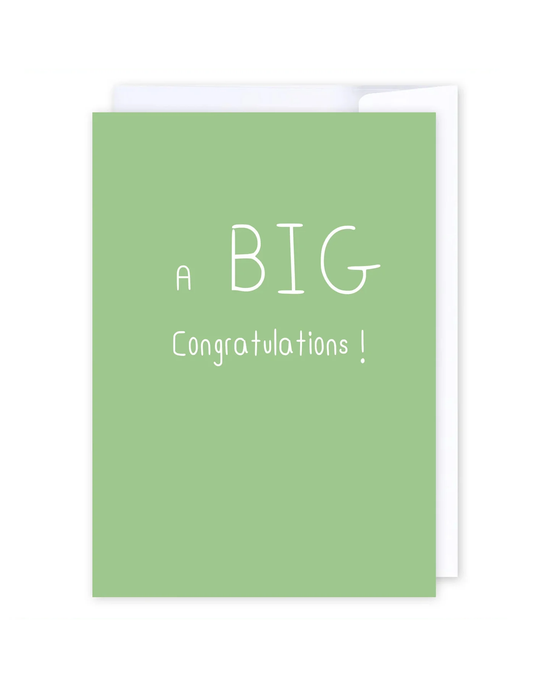 Certainly! Here’s a rewritten version using the product name: The “Big Congratulations” card is a green New Zealand greeting card featuring playful, varied white text that says, “A BIG Congratulations!” Centered on a blurred white and gray background, the card is shown slightly open