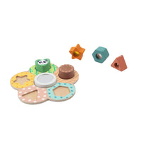Sensory Shape Board with several wooden shapes lifted out