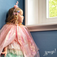 Souza Laurana glittering pink cape being worn